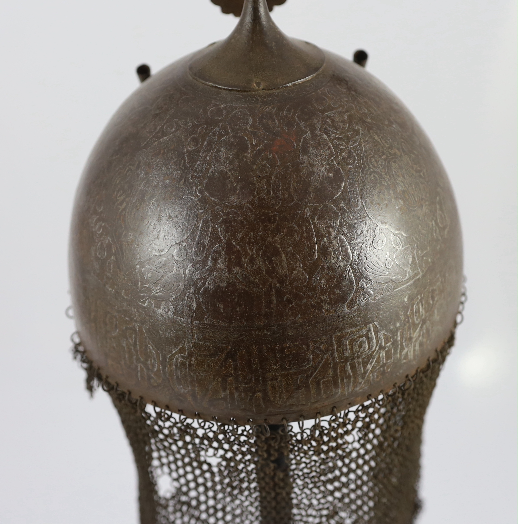 A 19th century Persian Kulah Khud, overall 60cm high, on ebonised stand including a section of human skull